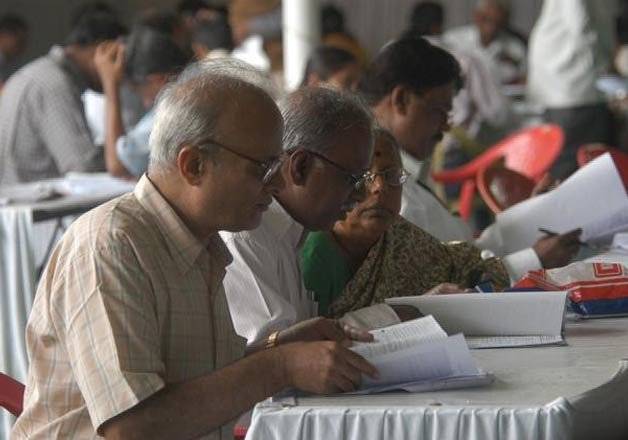 Senior Citizens checking something on papers